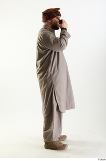 Luis Donovan Afgan Civil with Walkie-Talkie standing talking whole body…